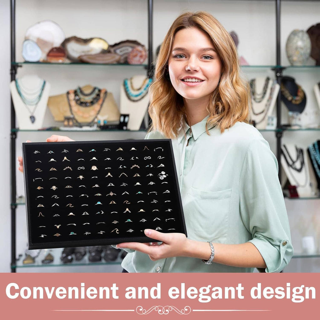 Black velvet-lined ring holder tray with 100 ring slots, held for display