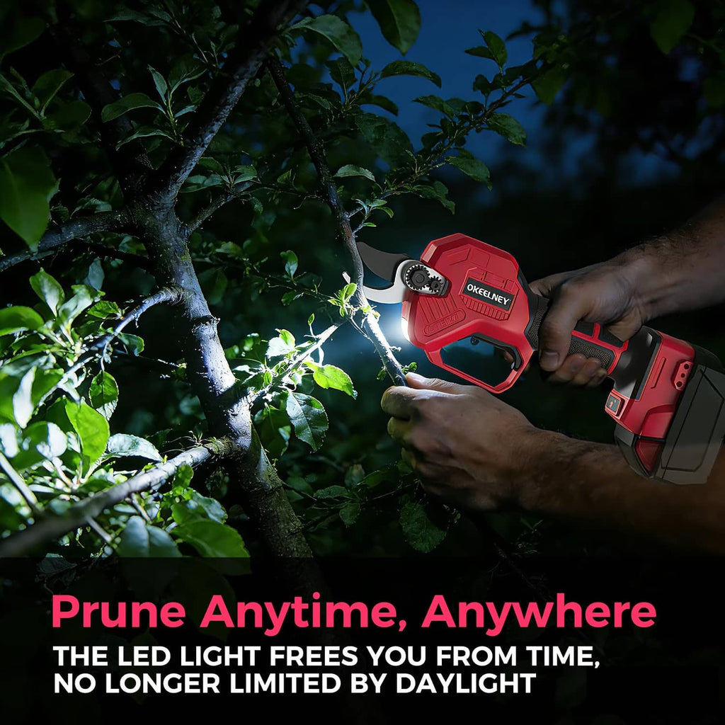 Red cordless pruning shears operating at night with LED light showing on the cutting area