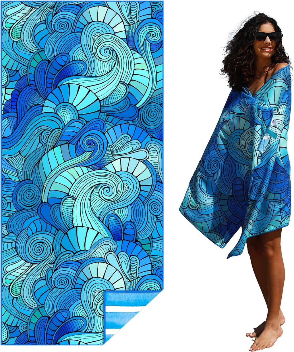 Blue swirl-pattern beach towel, draped and held by a person outdoors, lightweight style