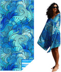Blue swirl-pattern beach towel, draped and held by a person outdoors, lightweight style