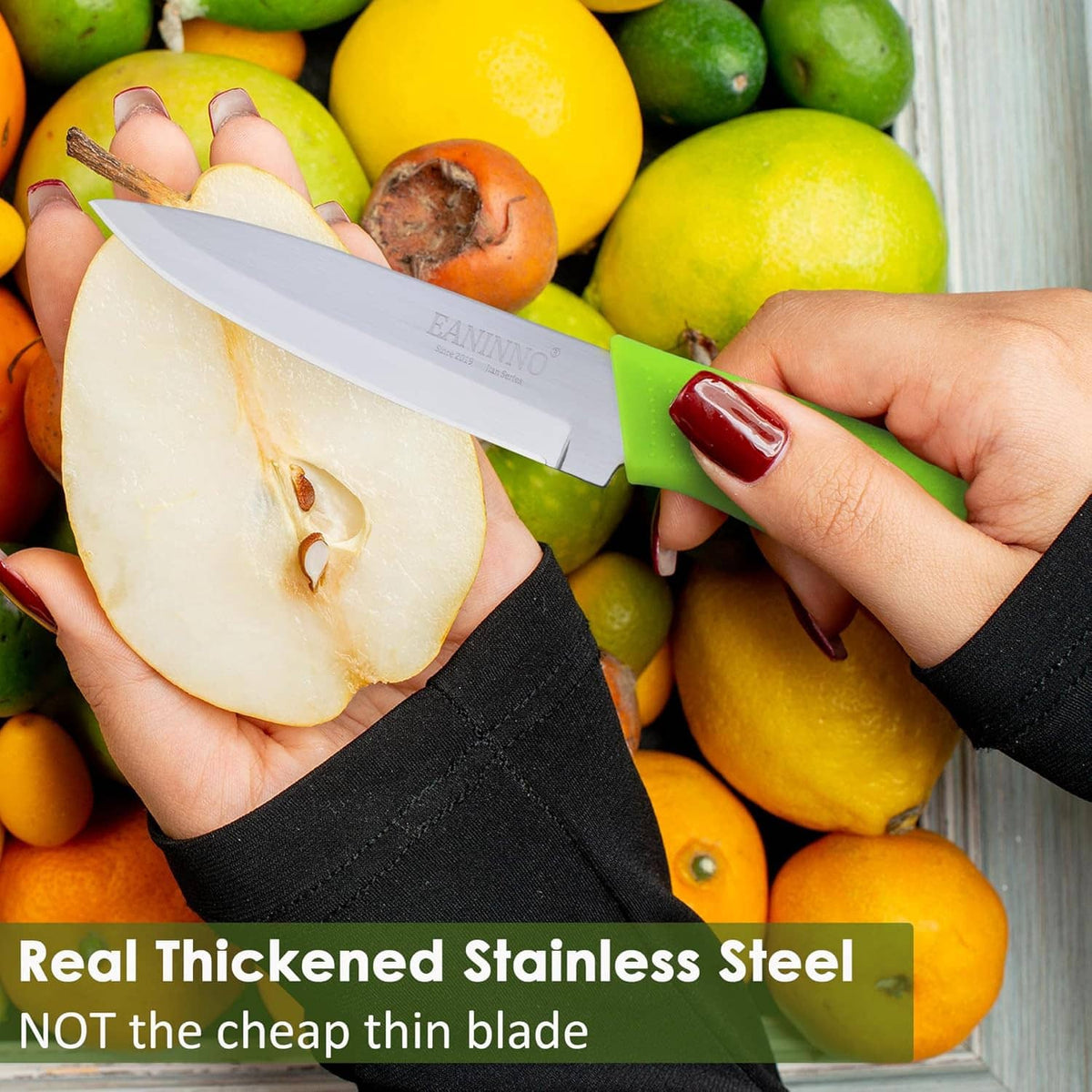 Paring knife with white blade and black handle cutting fruit in a hand