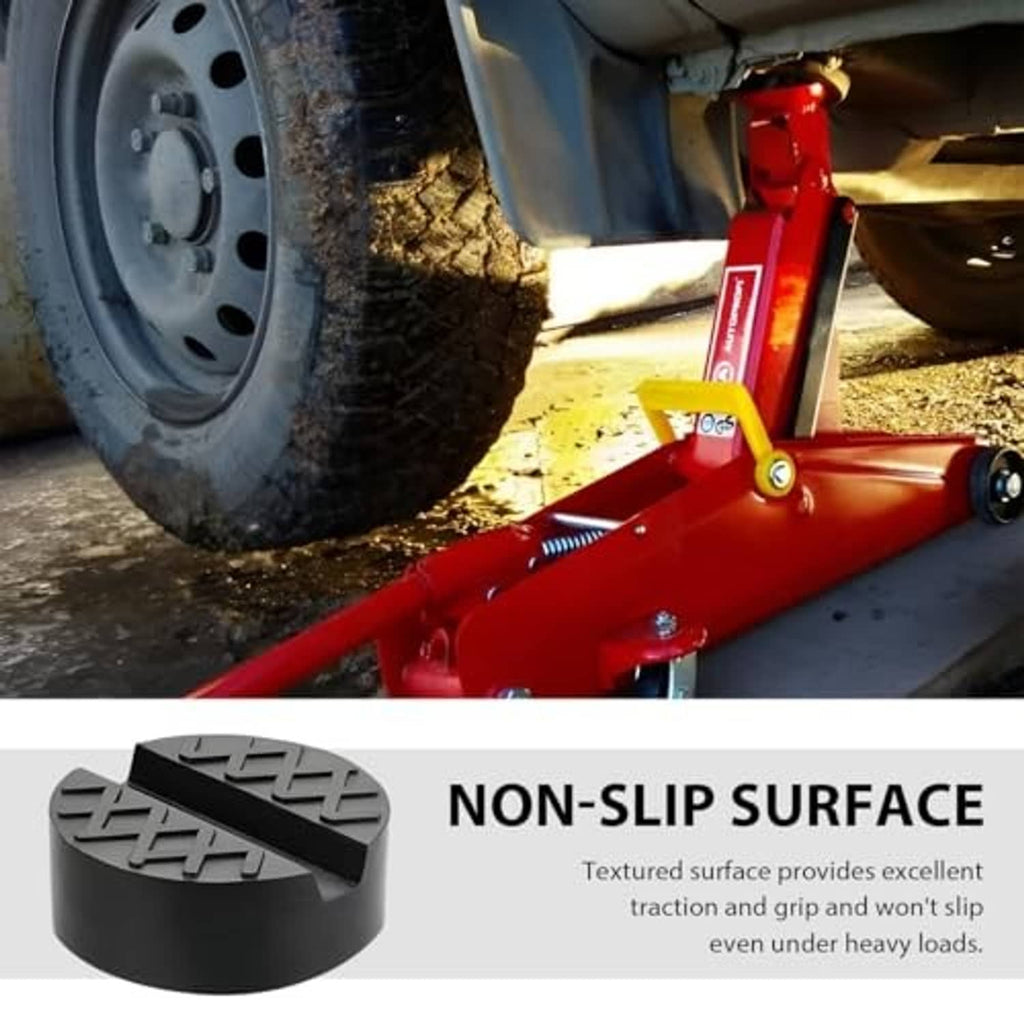 Black rubber jack pad placed under a red floor jack near the vehicle tire.