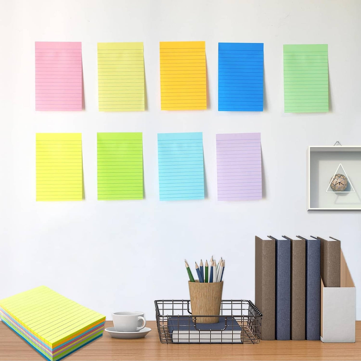 Multiple 4x6 lined sticky note pads in pastel and bright colors arranged on wall