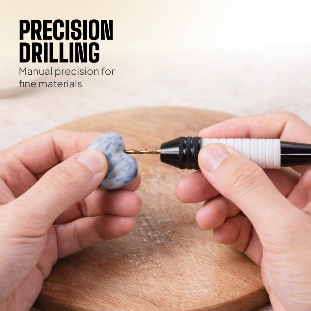 Pin vise drill tool with micro bit in use on stone, blue handle and white grip