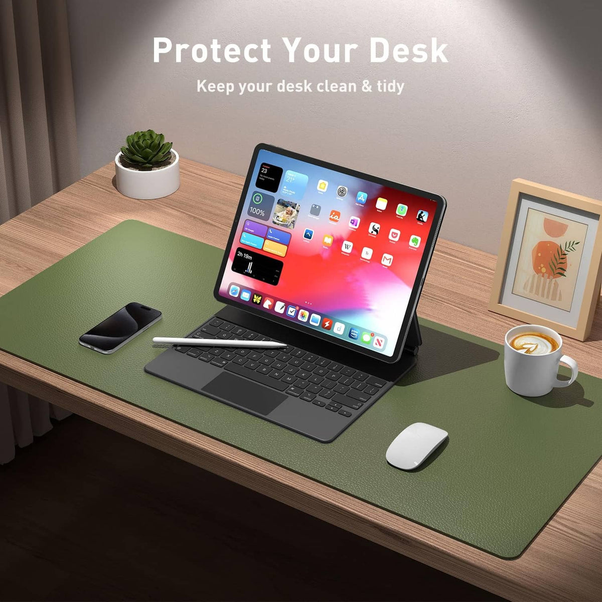 Olive green desk mat under laptop, mouse, and phone on a wooden desk