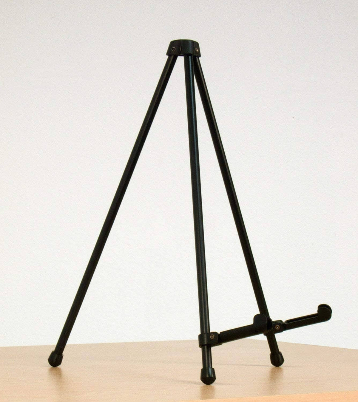 Black tabletop tripod easel with side clamp arm and rubber feet for stability