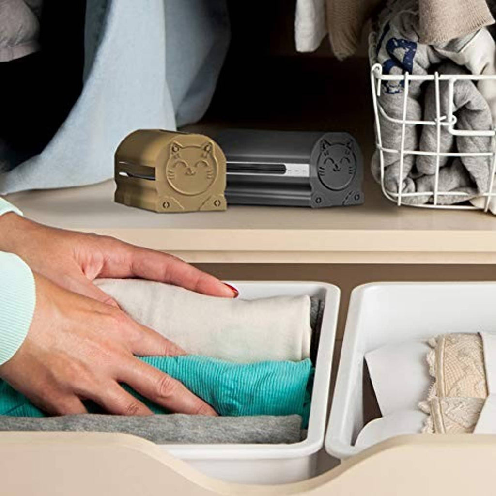 Black lint roller case inside a drawer with a lint roller and fabric