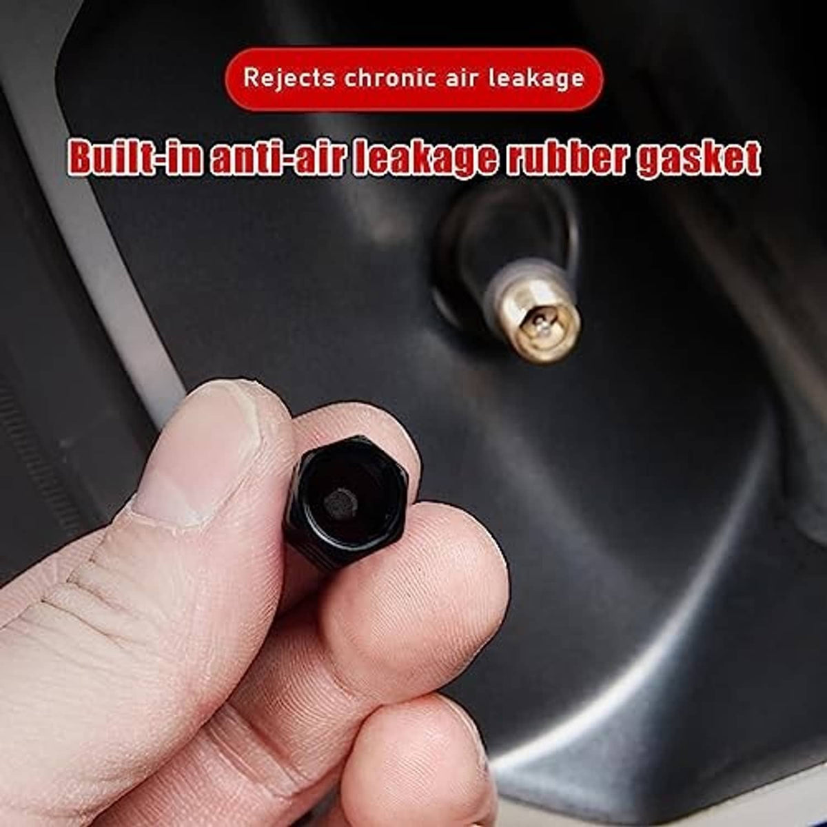Black valve stem cap held in hand over car wheel tire valve opening