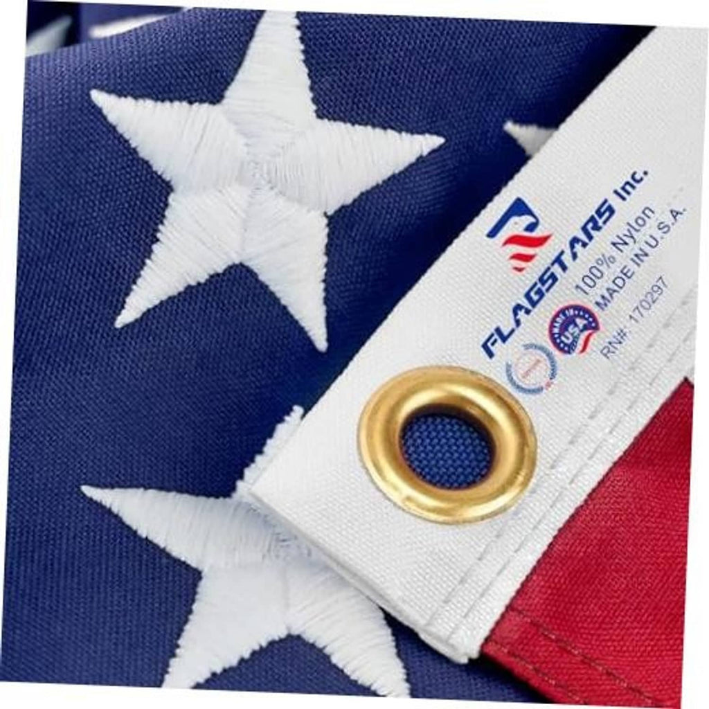 Close-up of American flag stars and stripes with brass grommet at the corner