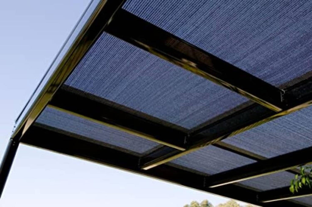 Black shade cloth panel laid over pergola roof beams