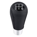 Black leather 5-speed shift knob with silver base and 1–5/R shift pattern