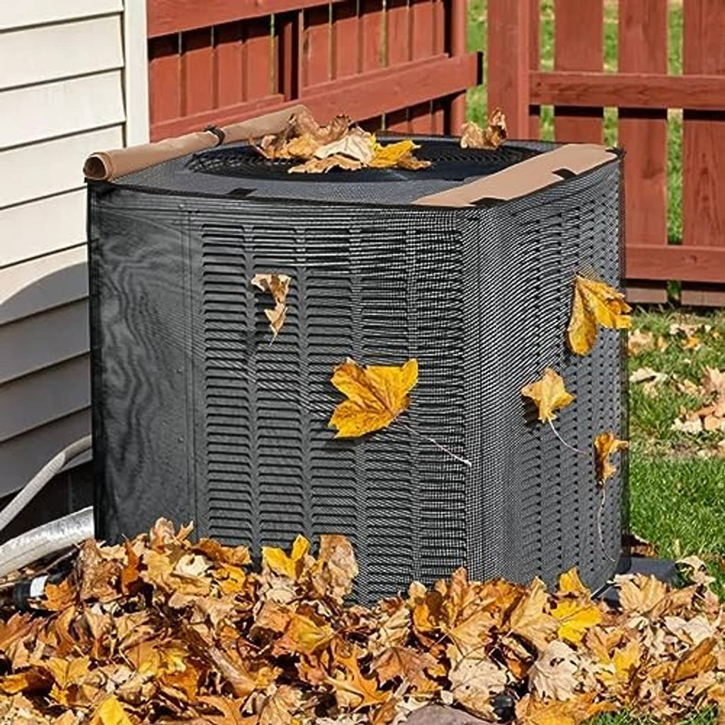 Square air conditioner cover with brown top, dark mesh sides, and leaf debris