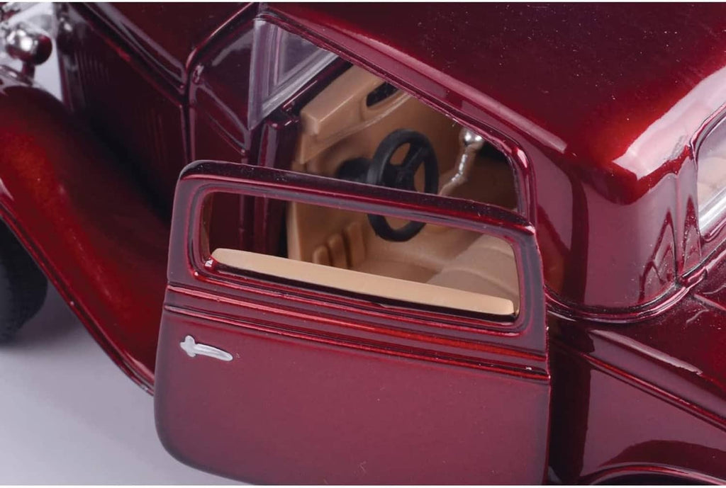 Red 1932 Ford coupe diecast model car close-up of driver window and interior dashboard.