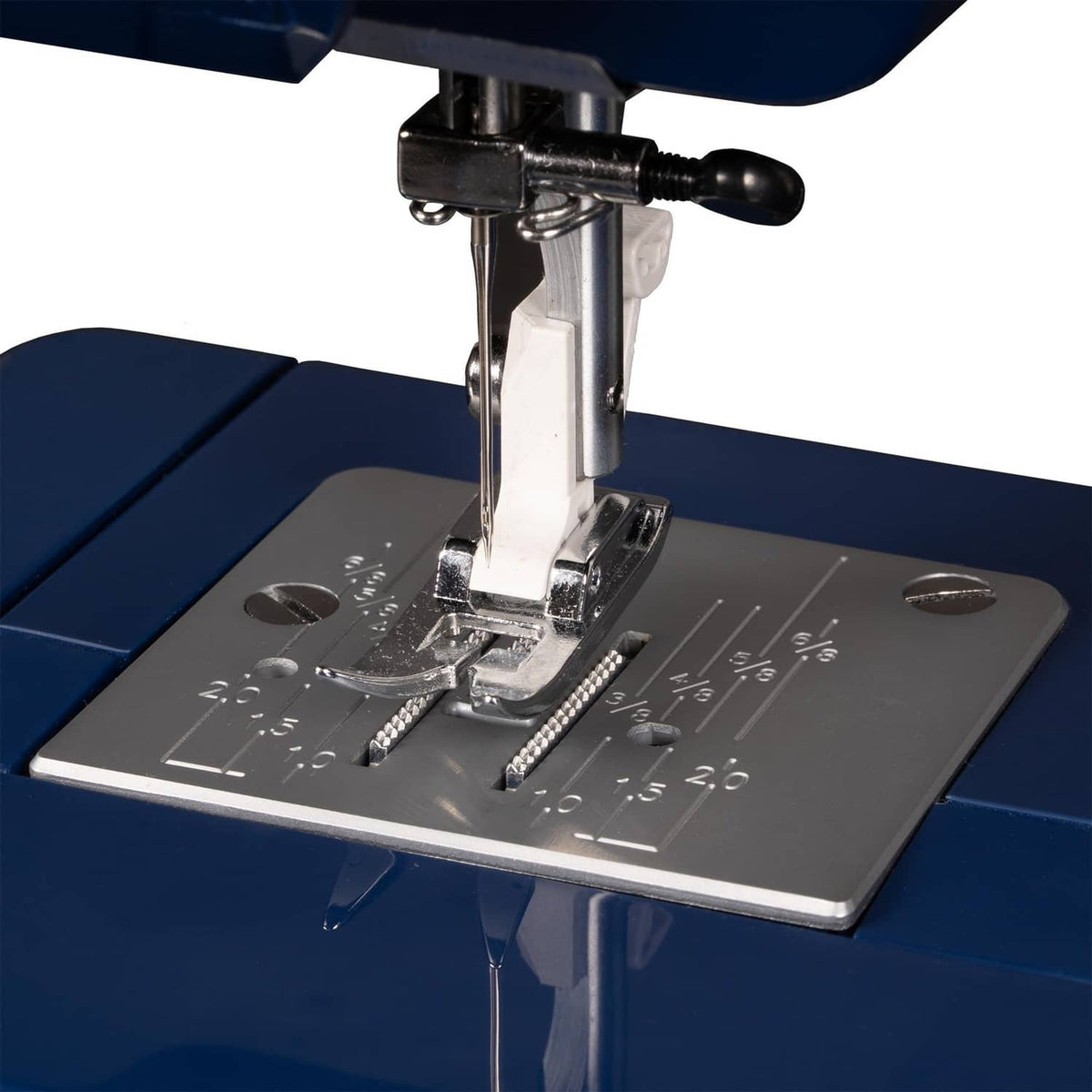 Sewing machine presser foot stitching over fabric with needle and throat plate