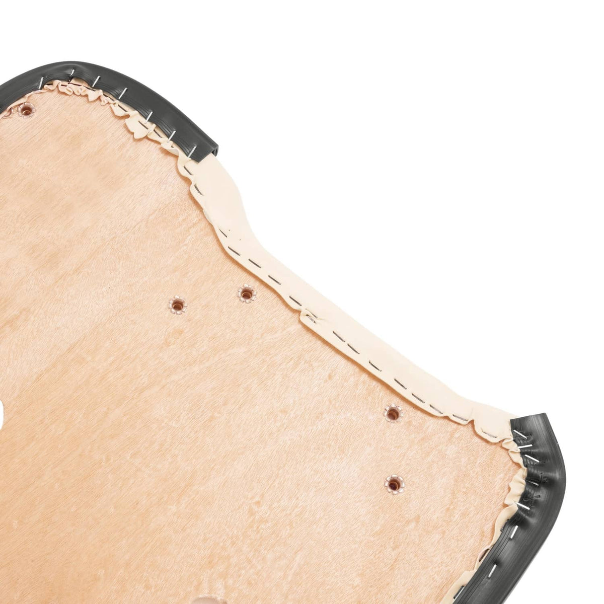 Close-up of beige underside board with black edge and white stitching