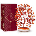 Carnelian crystal tree figurine with orange-red stones and white palm-stone base