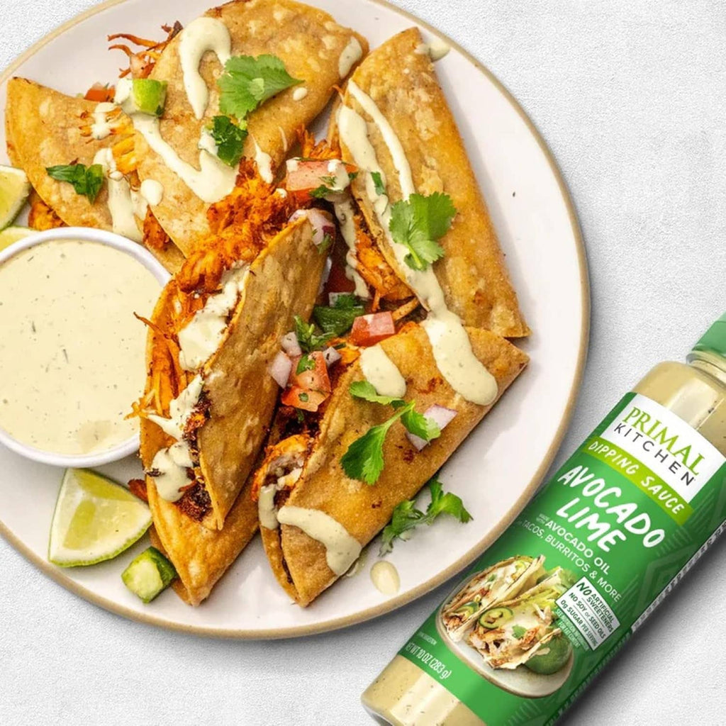 Avocado-lime dipping sauce served with tacos; bottle shown at right