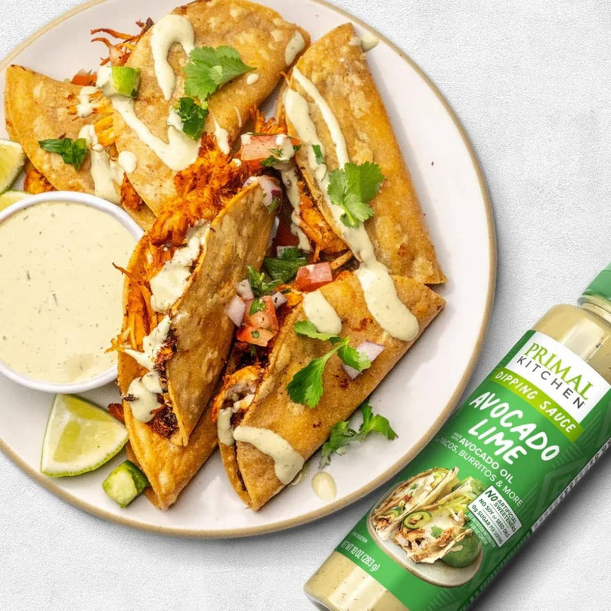 Avocado-lime dipping sauce served with tacos; bottle shown at right