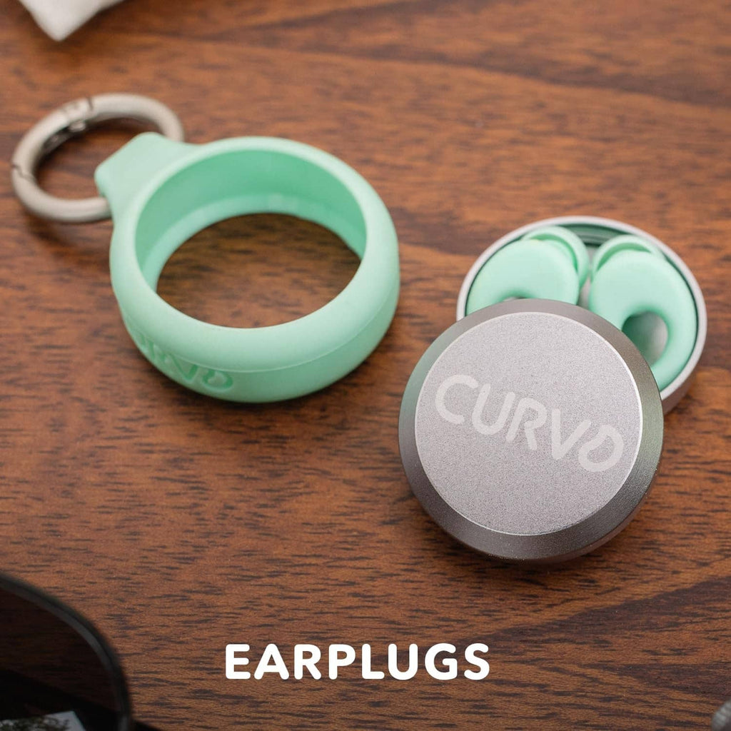 Mint and gray keychain case with silver lid holding earplugs
