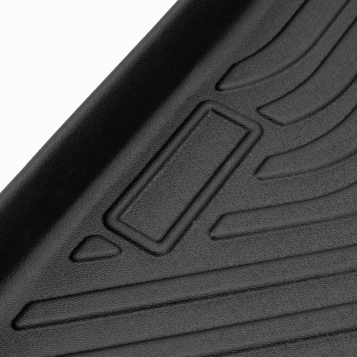 Black TPE floor mat corner detail with molded grip channels, close-up