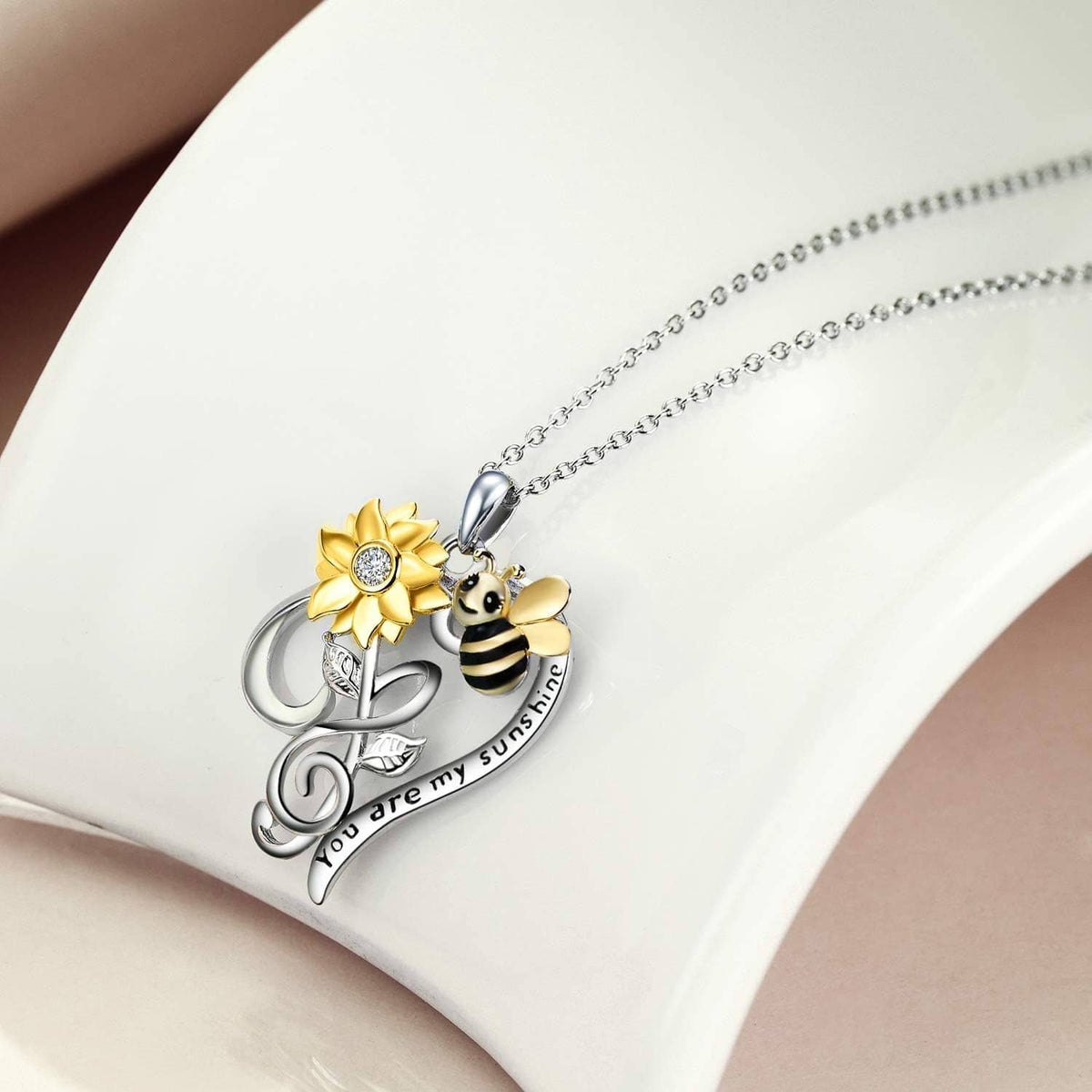 Bee and gold flower pendant on silver-tone chain