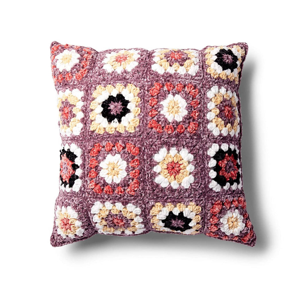 Multicolor crochet granny-square style pillow with floral motifs