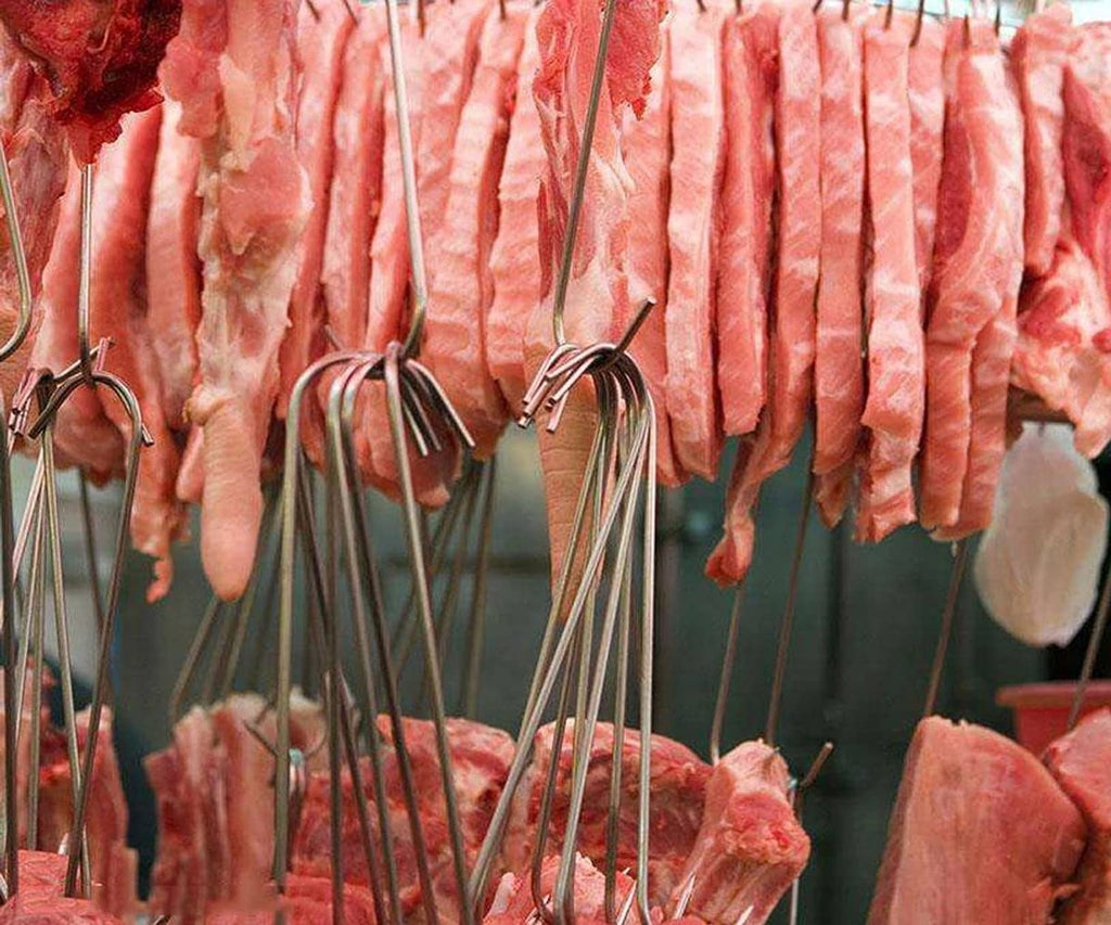 Stainless steel S-hooks hanging multiple cured meat pieces for processing