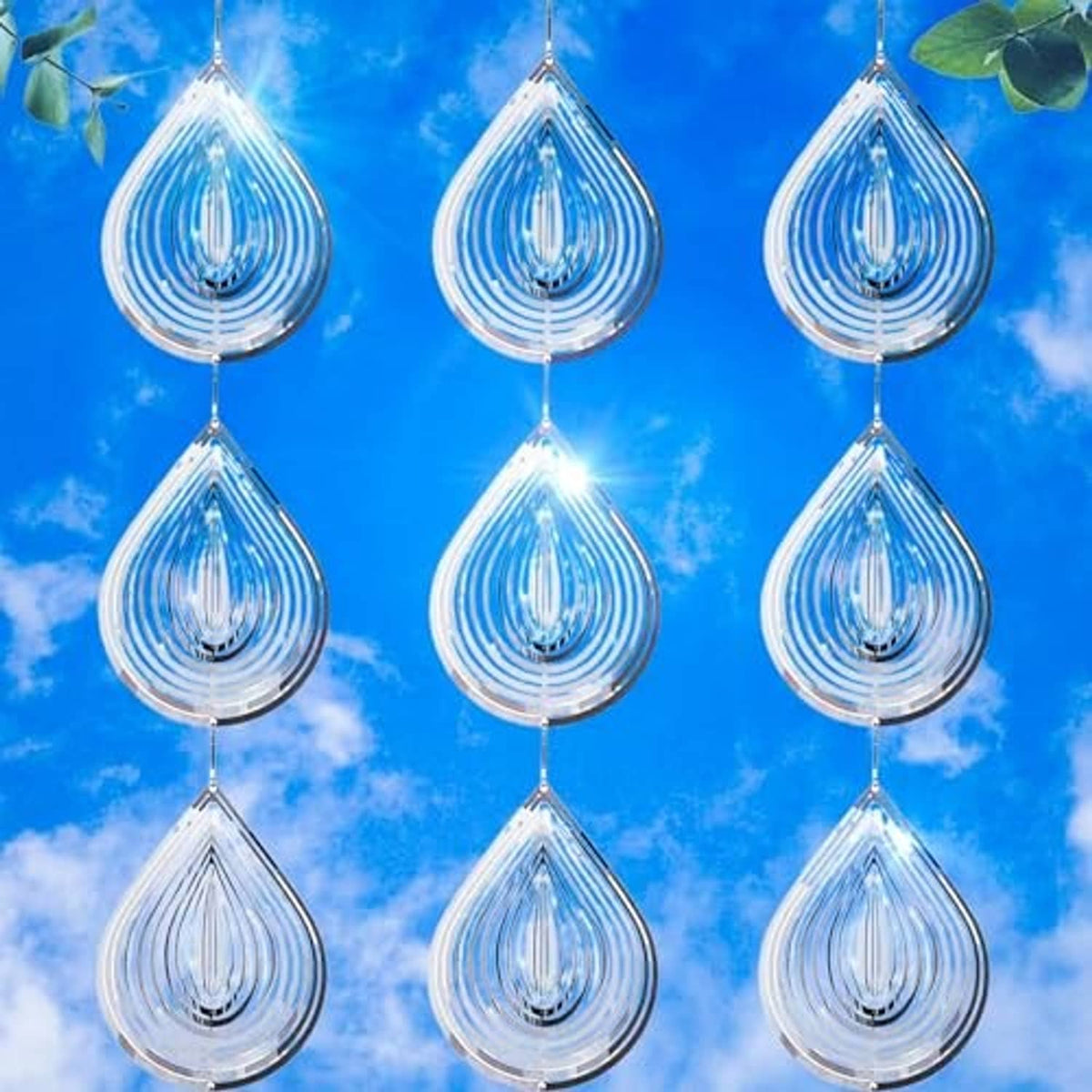 Multiple silver reflective teardrop bird scare discs hanging in rows with water-droplet effect
