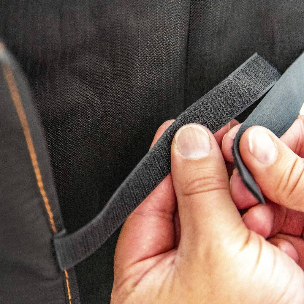 Black fabric smoker cover strap with adjustable webbing and hook-and-loop closure
