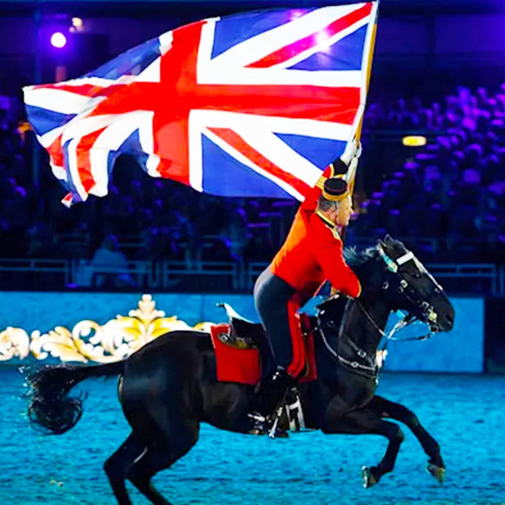 Union Jack flag waving above horse during event, red center cross on blue and white