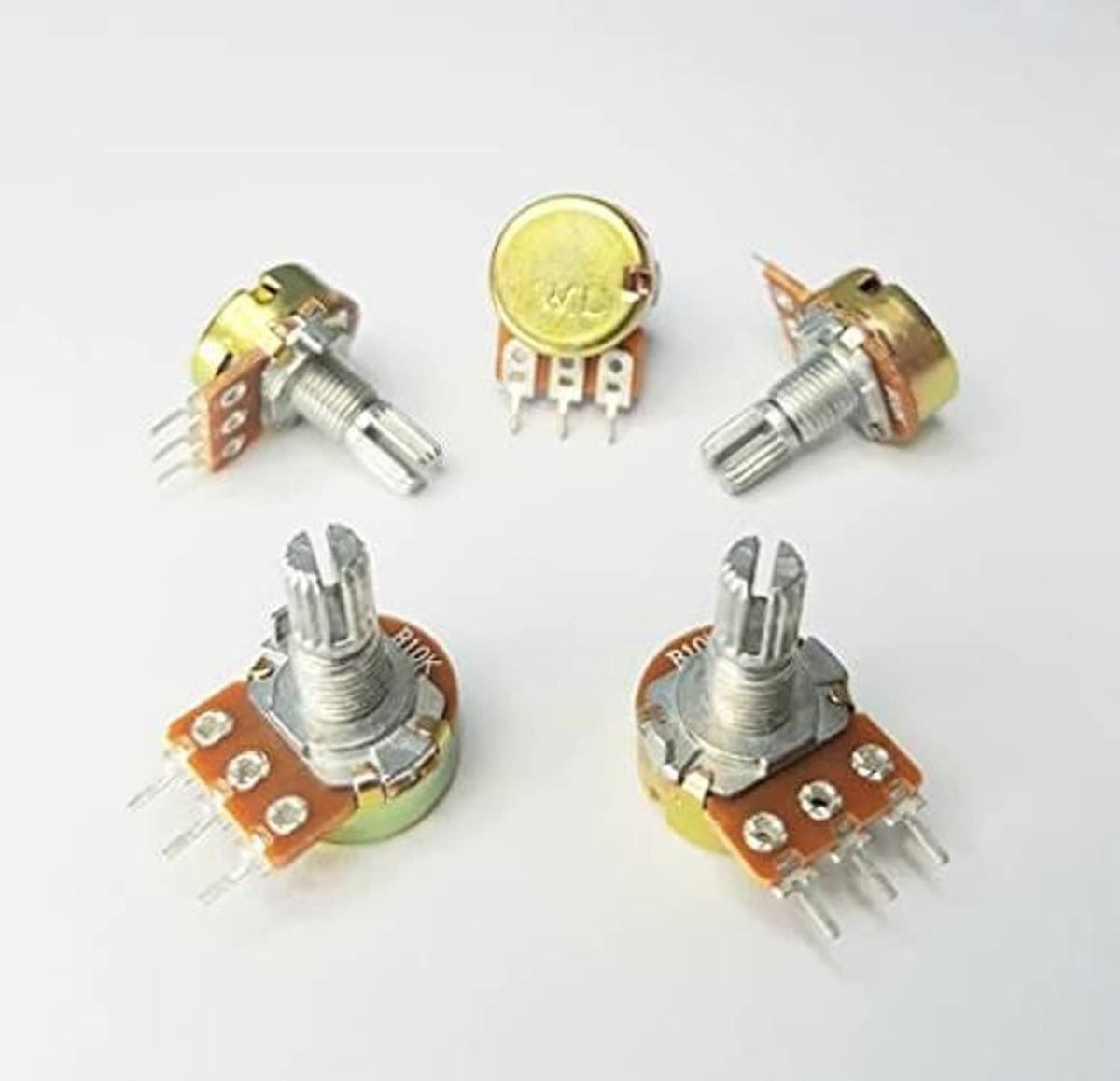 Assorted 10K ohm potentiometers with metal shafts and orange circuit boards, pin leads
