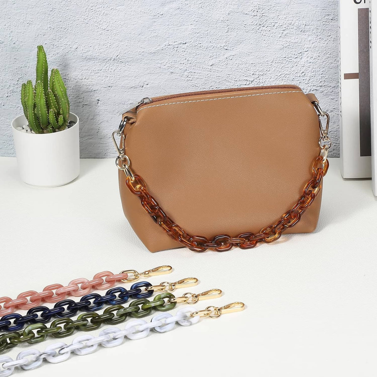Blue acrylic chain strap with gold-tone links and clasp ends for a handbag