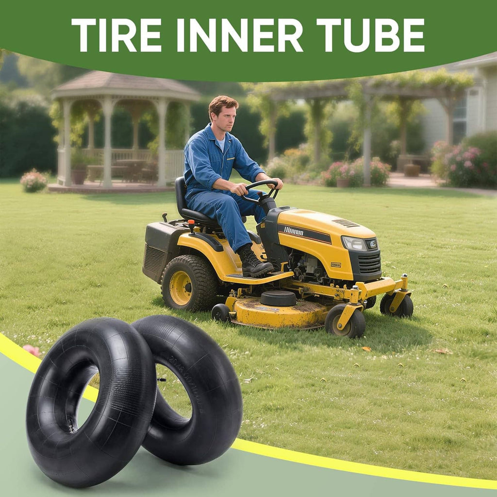 Two black tire inner tubes with valve stems near a lawn tractor on grass