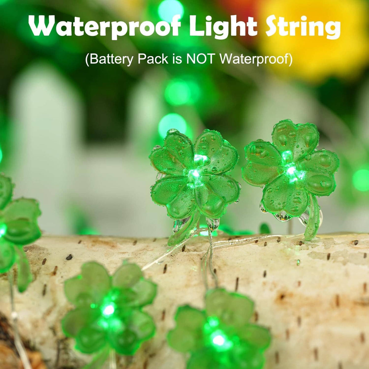 Green shamrock string lights glowing on a birch log with small LED clover flowers