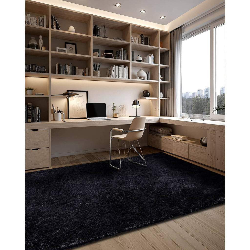 Black plush area rug on wood floor in an office space with desk and shelves