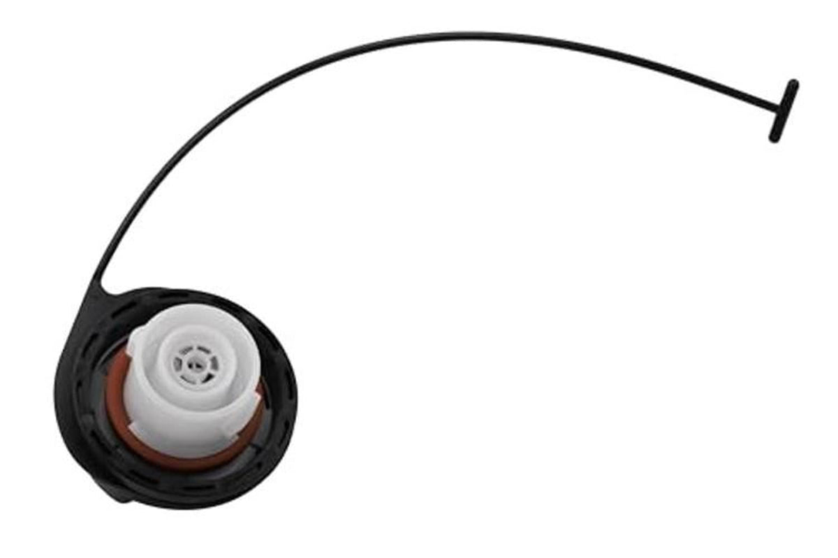 Black fuel tank filler cap underside with white seal and central vent opening