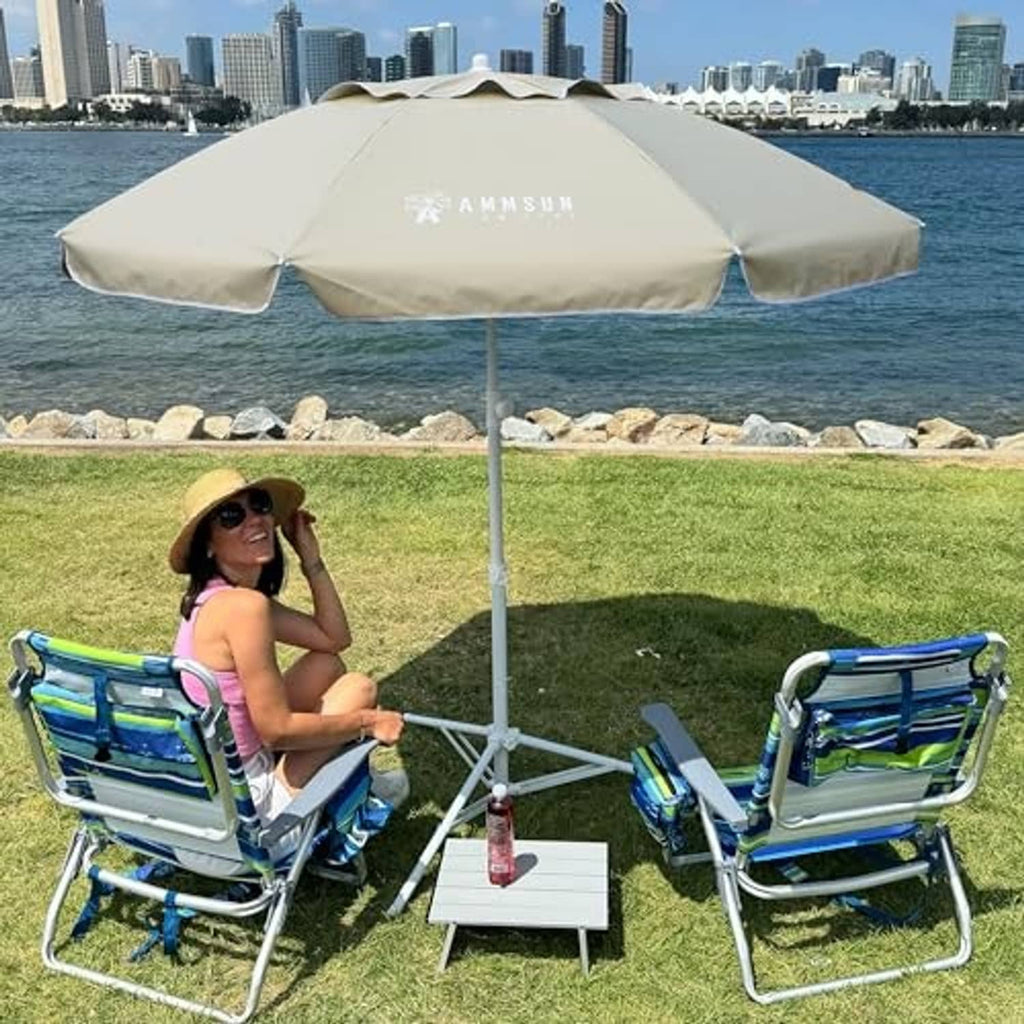 Beige patio umbrella shade with white tripod stand and central pole