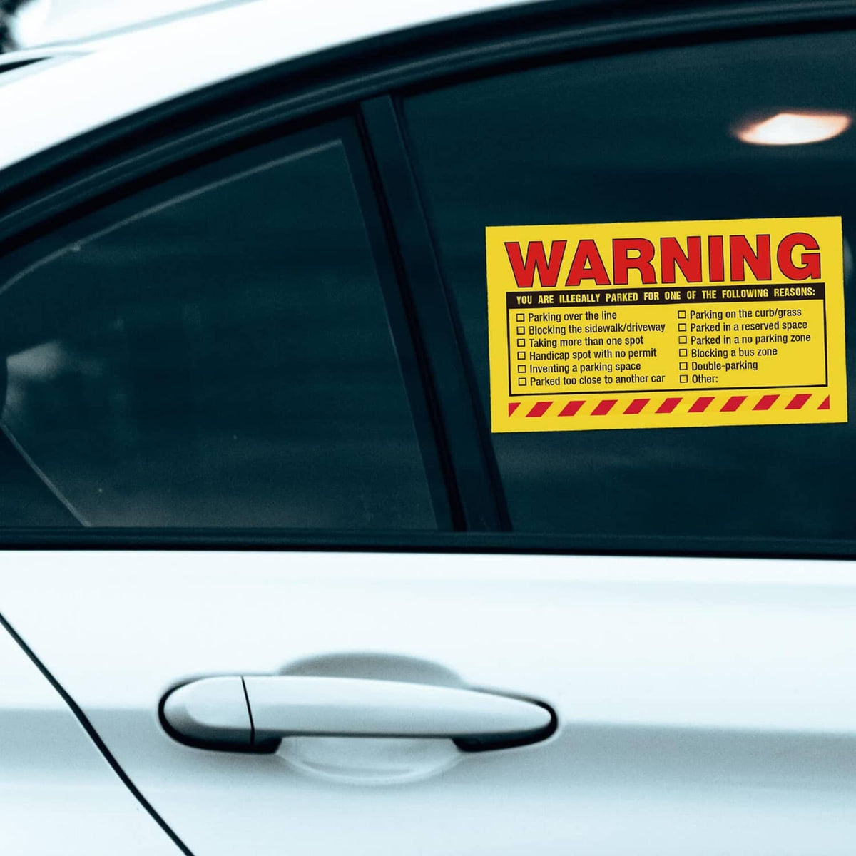 Yellow warning parking violation sticker on car window