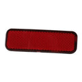 Red rear bumper reflector with textured lens and black border frame