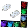 Two oval wireless LED light modules for car interior, with multicolor ambient glow.