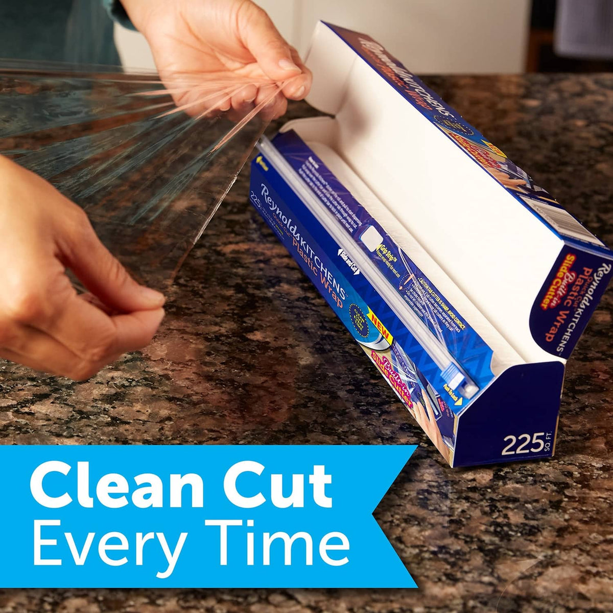 Plastic wrap roll being pulled from Reynolds Kitchens box for clean coverage