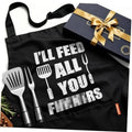 Black cooking apron with bold white slogan and utensil icons