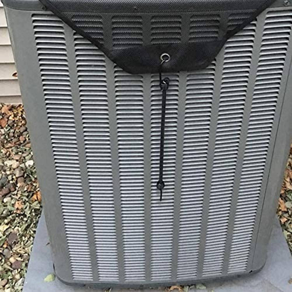 Central AC unit cover close-up of gray ribbed panel with black corner strap loop.