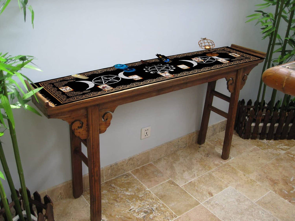 Black altar cloth with gold border and moon/pentagram designs on bench