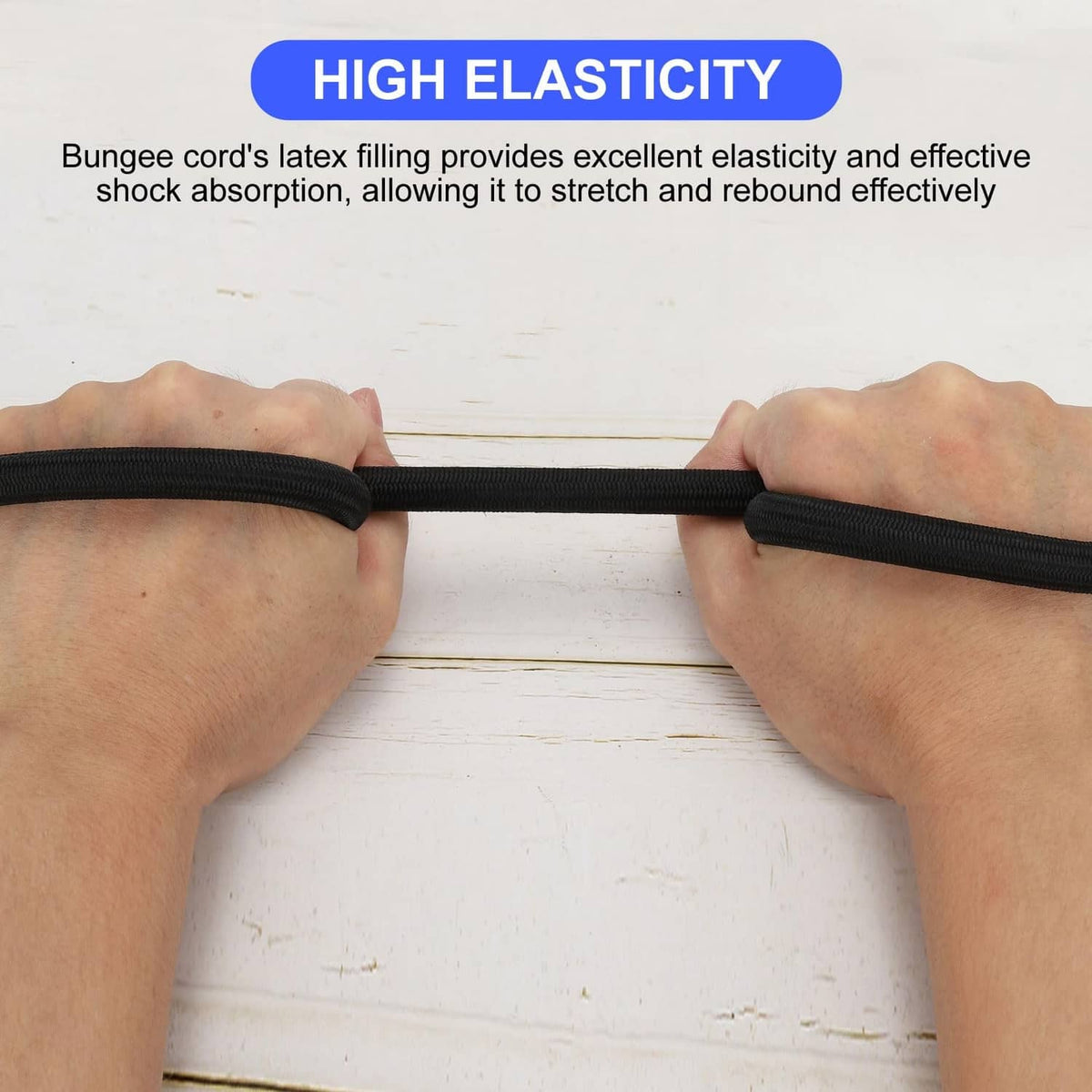 Black bungee shock cord stretched between hands, showing elastic stretch