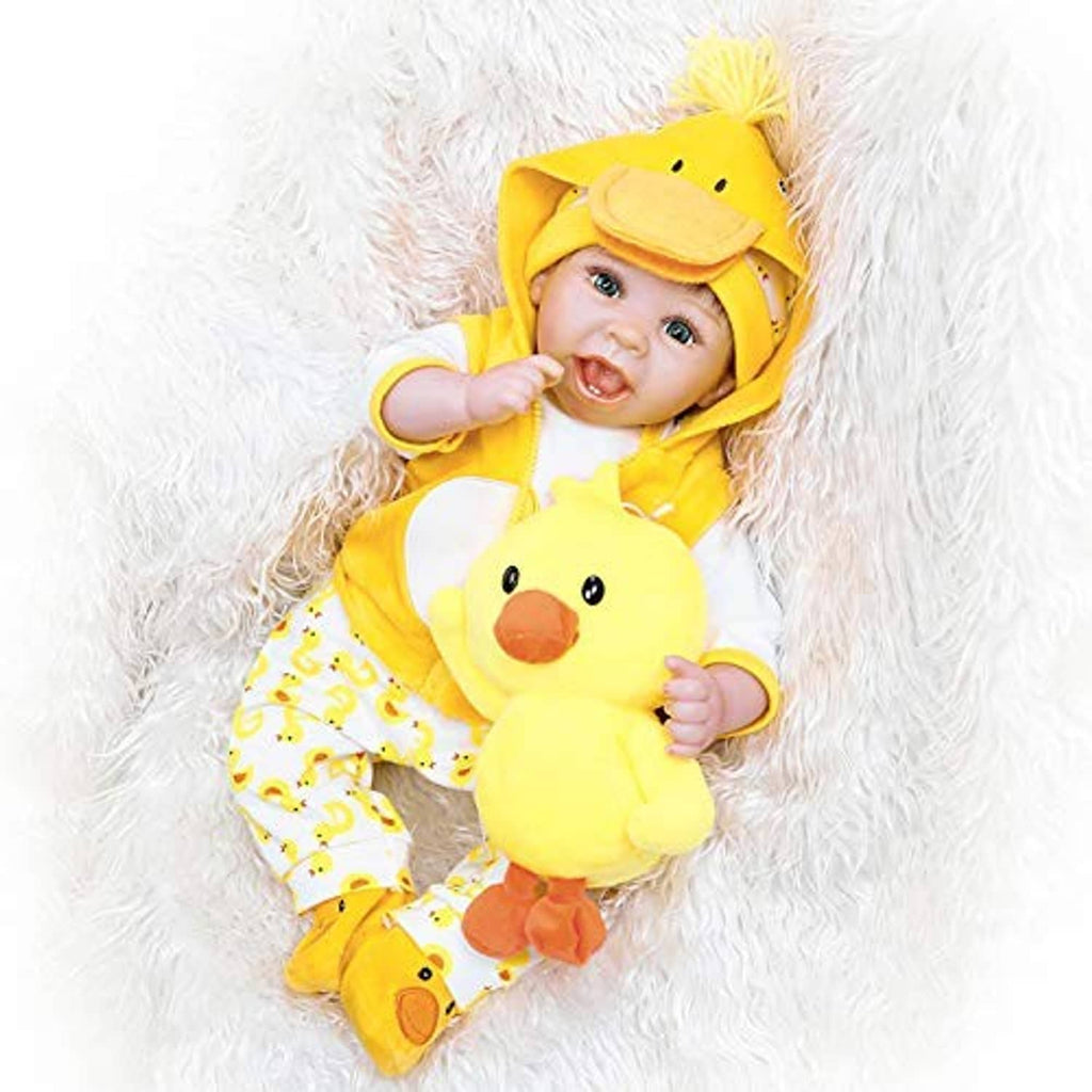 Baby doll in yellow duck hooded outfit with patterned pants and matching hat