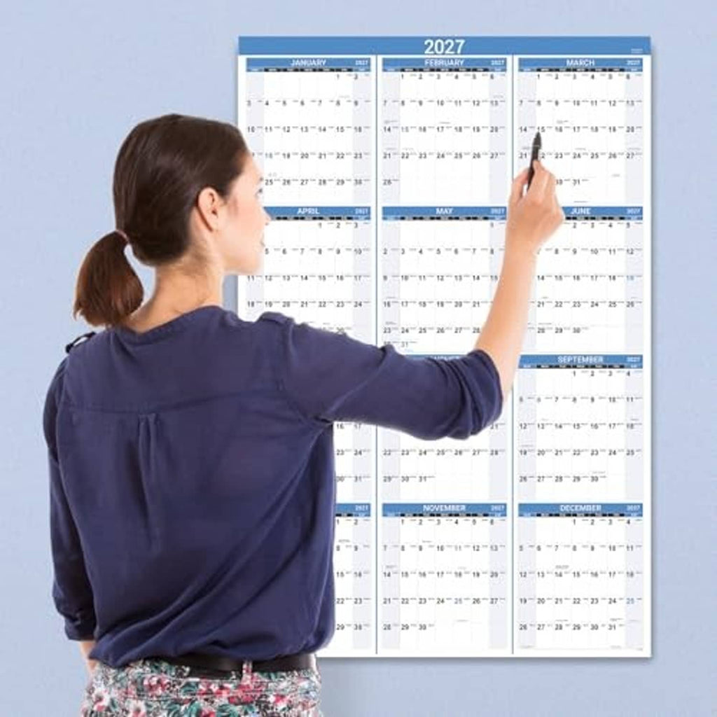 2027 wall calendar mounted on a wall, with blue month bars and date rows.