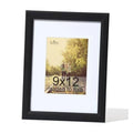 Black woodgrain picture frame with white mat, display opening for 9x12 photos