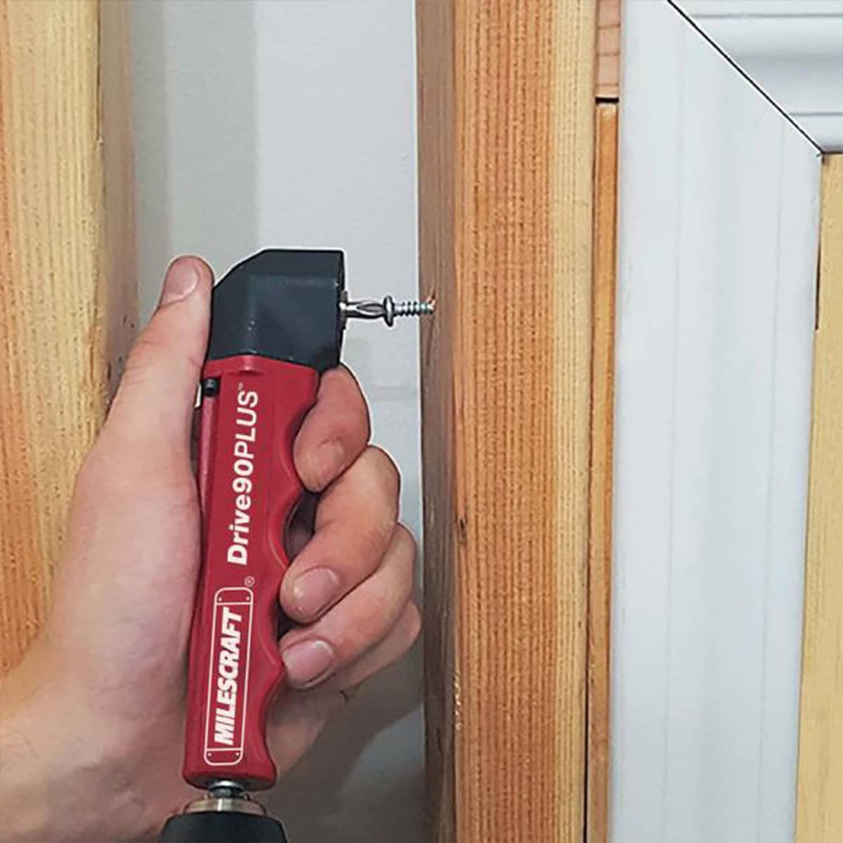 Milescraft right-angle drill attachment with red housing and black head, mounted drill bit
