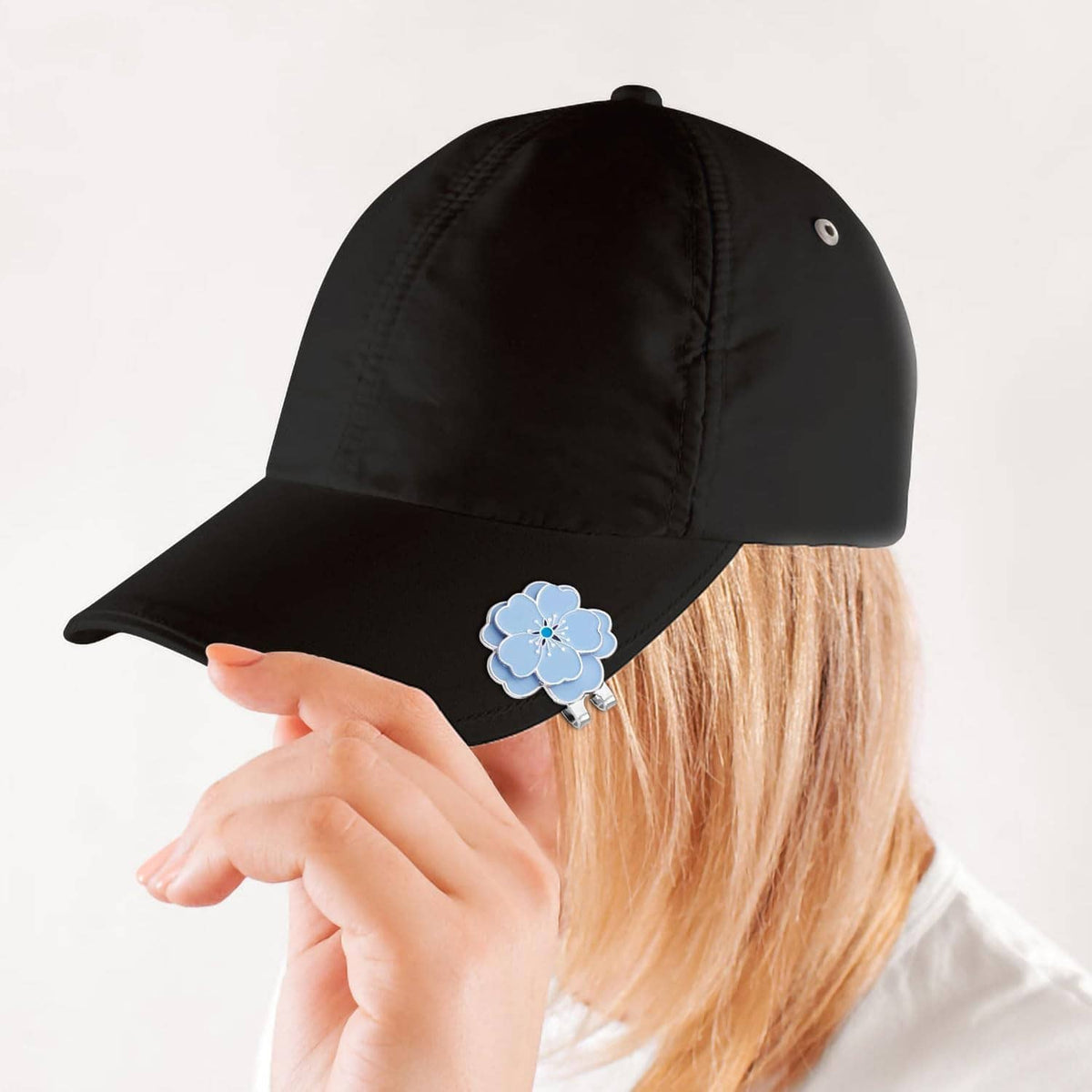 Blue flower magnetic clip on black golf cap brim